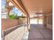 View of an extended covered patio with gravel, leading to a backyard area at 1613 Glenrosa Dr, North Las Vegas, NV 89031