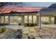 Back exterior view showcases a patio, landscaped backyard, and large picture windows at 1805 Prichard Ave, Henderson, NV 89052