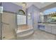 Bright bathroom with a soaking tub, glass shower, and vanity at 1805 Prichard Ave, Henderson, NV 89052