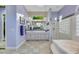 Well-lit bathroom featuring a soaking tub, glass shower, and dual sink vanity at 1805 Prichard Ave, Henderson, NV 89052