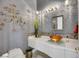 Well-lit bathroom features a vessel sink, decorative mirror, and unique wall art at 1805 Prichard Ave, Henderson, NV 89052