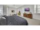 Well lit bedroom with white walls, wooden accents, and a television at 1805 Prichard Ave, Henderson, NV 89052