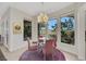 Cozy dining area with a modern chandelier and large windows overlooking the outdoor landscape at 1805 Prichard Ave, Henderson, NV 89052