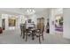 Elegant dining room with a chandelier, comfortable seating, and a view into other parts of the open floorplan at 1805 Prichard Ave, Henderson, NV 89052