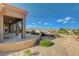 Backyard featuring a covered patio, desert landscaping, and scenic views at 1904 Hot Oak Ridge St, Las Vegas, NV 89134