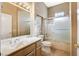 Bathroom features light cabinets, shower and bath combo, tile flooring, and a large vanity with sink at 1904 Hot Oak Ridge St, Las Vegas, NV 89134