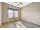 Bedroom features carpet floors, a ceiling fan, base molding and windows with coverings allowing for natural light at 1904 Hot Oak Ridge St, Las Vegas, NV 89134
