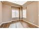 Bright bedroom features hardwood floors, a ceiling fan, and multiple windows with natural light at 1904 Hot Oak Ridge St, Las Vegas, NV 89134