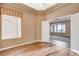 Light-filled bedroom with hardwood floors leading to an open doorway into the next room at 1904 Hot Oak Ridge St, Las Vegas, NV 89134