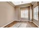 Cozy bedroom features hardwood floors, a neutral color scheme, a window with blinds and curtains, and recessed lighting at 1904 Hot Oak Ridge St, Las Vegas, NV 89134