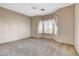 Bedroom features carpet floors, base molding, a ceiling fan and windows with coverings allowing for natural light at 1904 Hot Oak Ridge St, Las Vegas, NV 89134
