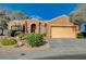 Charming single-story home featuring a well-manicured front yard with desert landscaping and an attached two-car garage at 1904 Hot Oak Ridge St, Las Vegas, NV 89134