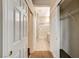 Hallway with a view of the bathroom and closet space, featuring tile and carpet flooring at 1904 Hot Oak Ridge St, Las Vegas, NV 89134