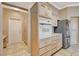Kitchen features tile flooring, light cabinets, stainless steel appliances and flows into the hallway and pantry at 1904 Hot Oak Ridge St, Las Vegas, NV 89134