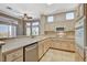 Bright kitchen features tile floors, light cabinets, modern appliances, and a breakfast bar with beautiful outdoor views at 1904 Hot Oak Ridge St, Las Vegas, NV 89134