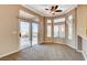 Cozy living room with carpet, sliding glass doors, and multiple windows letting in natural light at 1904 Hot Oak Ridge St, Las Vegas, NV 89134