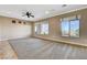 Expansive living room featuring large windows, tile flooring, recessed lighting, and a ceiling fan at 1904 Hot Oak Ridge St, Las Vegas, NV 89134