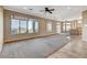 Bright living room showcasing large windows with scenic views, a ceiling fan, and tile flooring at 1904 Hot Oak Ridge St, Las Vegas, NV 89134
