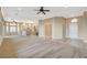 Open living space with tile flooring transitioning to carpet and an open kitchen and dining area at 1904 Hot Oak Ridge St, Las Vegas, NV 89134