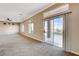 Spacious living room with a ceiling fan, sliding glass doors, and a neutral color palette at 1904 Hot Oak Ridge St, Las Vegas, NV 89134