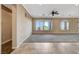 Spacious living room featuring tile flooring, large windows providing natural light, and a ceiling fan at 1904 Hot Oak Ridge St, Las Vegas, NV 89134