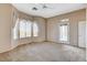 Spacious main bedroom featuring large windows, neutral tones, and a ceiling fan for optimal comfort at 1904 Hot Oak Ridge St, Las Vegas, NV 89134
