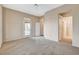 Bright main bedroom with a door to the patio, neutral colors, and an en-suite bathroom entrance at 1904 Hot Oak Ridge St, Las Vegas, NV 89134