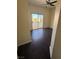 Cozy bedroom featuring sleek dark wood flooring and a sliding door to a balcony at 1941 Golden Trumpet Ave, Las Vegas, NV 89123