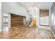 Open floor plan with decorative wooden wall, and staircase with hardwood floors throughout at 209 Camino Vista St, Henderson, NV 89012