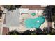 Overhead view of a kidney bean-shaped community pool, hot tub, and lounge furniture at 2124 Willowbury Dr # D, Las Vegas, NV 89108