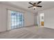 Bright bedroom with a ceiling fan, slider door to backyard, and view to the attached bathroom at 2124 Willowbury Dr # D, Las Vegas, NV 89108