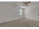 A bright bedroom with carpet and a large window for plenty of light at 2124 Willowbury Dr # D, Las Vegas, NV 89108