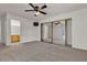 Bedroom with carpet, ceiling fan, mirrored closets and an ensuite bathroom at 2124 Willowbury Dr # D, Las Vegas, NV 89108