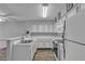 Cozy kitchen featuring white cabinets, modern appliances, and wood-look flooring at 2124 Willowbury Dr # D, Las Vegas, NV 89108