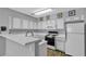 Traditional kitchen featuring white cabinets, laminate countertops, and modern appliances at 2124 Willowbury Dr # D, Las Vegas, NV 89108