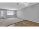 Open living room featuring plush carpet, laminate flooring, and a modern ceiling fan at 2124 Willowbury Dr # D, Las Vegas, NV 89108