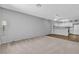 Open living room features plush carpet, laminate flooring, and adjacent kitchen at 2124 Willowbury Dr # D, Las Vegas, NV 89108