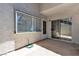 Covered outdoor patio area featuring dual sliding glass doors and hose at 2124 Willowbury Dr # D, Las Vegas, NV 89108