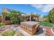 Spacious backyard features an outdoor spa, a covered patio, and lush landscaping at 2216 Sapphire Valley St, Las Vegas, NV 89128