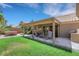 Covered patio in backyard with outdoor seating area and well-maintained lawn at 2216 Sapphire Valley St, Las Vegas, NV 89128