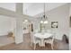 Open-concept dining area with tiled flooring, a modern chandelier, and easy access to other living spaces at 2216 Sapphire Valley St, Las Vegas, NV 89128