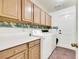 Functional laundry room with ample storage cabinets, counter space, and modern washer and dryer at 2216 Sapphire Valley St, Las Vegas, NV 89128