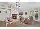 Inviting living room with a cozy fireplace, ceiling fan, and comfortable seating, perfect for relaxation at 2216 Sapphire Valley St, Las Vegas, NV 89128