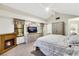 Spacious primary bedroom with a vaulted ceiling, fireplace, television, and an ensuite bathroom at 2216 Sapphire Valley St, Las Vegas, NV 89128