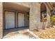 Condo entryway featuring dual security doors, stucco facade, and rock garden at 2606 Durango Dr # 181, Las Vegas, NV 89117