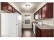 Kitchen featuring wood floors, matching appliances, and natural light at 2606 Durango Dr # 181, Las Vegas, NV 89117