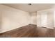 Spacious living room with hardwood floors and two entry doors at 2606 Durango Dr # 181, Las Vegas, NV 89117