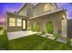 Private backyard featuring a well-maintained artificial turf, landscaping, and elegant lighting creating a peaceful ambiance at 3058 Casarano Ct, Henderson, NV 89044