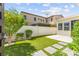 Serene backyard featuring artificial turf, stepping stones, and lush landscaping, perfect for relaxation and entertaining at 3058 Casarano Ct, Henderson, NV 89044