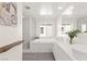 Bright bathroom features double sinks, soaking tub, step-in shower, and ample natural light at 3058 Casarano Ct, Henderson, NV 89044